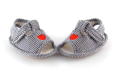Image showing Baby shoes on the white with red hearts