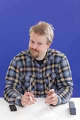 Image showing Displeased Business Manager At His Office Desk