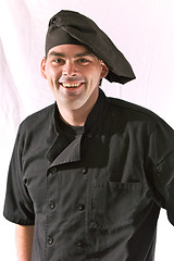 Image showing smiling chef in black uniform