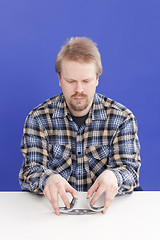 Image showing Man Mixes Cards