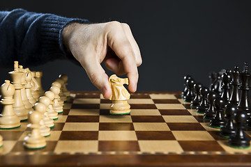 Image showing Hand moving knight on chess board