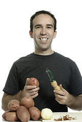 Image showing Man Peeling Potatoes