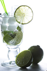 Image showing Limes at mojito cocktail glass in counter light