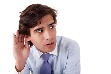 Image showing Young businessman, listening, viewing the  gesture of hand behind ear