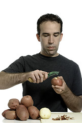 Image showing Man Peeling Potatoes