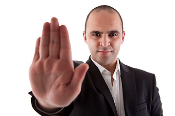 Image showing man with his hand raised in signal to stop
