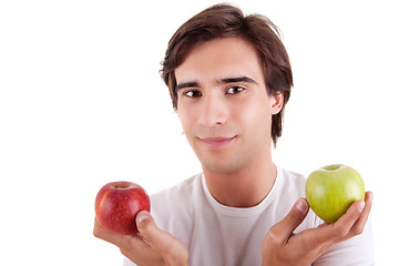 Image showing Portrait of a young man with two apples in their hands: green and red
