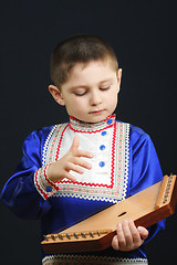 Image showing Little boy playing gusli