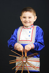 Image showing Little boy playing clapper