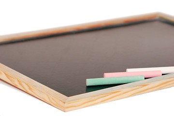 Image showing stick of color chalk on a blackboard isolated background