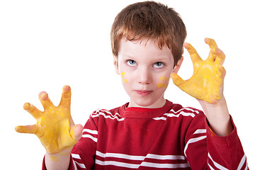 Image showing Kid playing with yellow paint