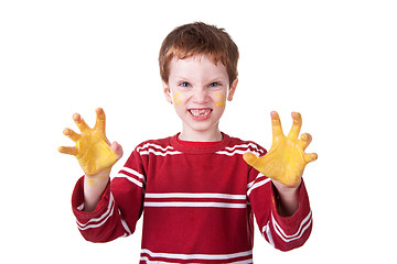 Image showing Happy Kid playing with yellow paint