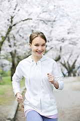 Image showing Girl jogging in park