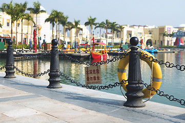 Image showing Yellow life buoy on fence