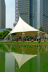 Image showing Reflection of skyscrapers and tent over lake