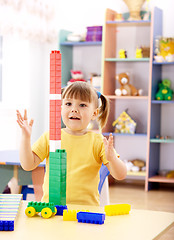 Image showing Little girl play with building bricks in preschool