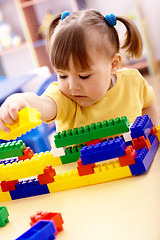 Image showing Little girl play with building bricks in preschool