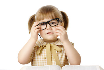 Image showing Happy little girl with book wearing black glasses