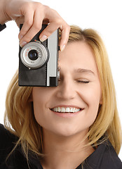 Image showing young woman taking a shot with photo camera