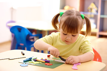 Image showing Little girl play with plasticine in preschool