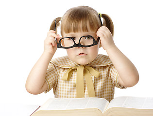 Image showing Cute little girl with book wearing black glasses