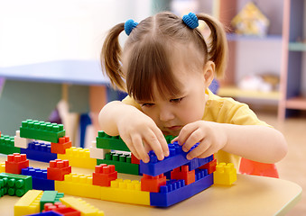 Image showing Little girl play with building bricks in preschool