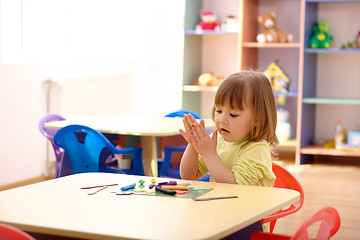 Image showing Little girl play with plasticine in preschool