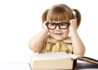 Image showing Happy little girl with book wearing black glasses