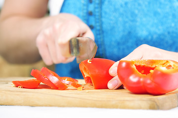 Image showing Woman hands cutting paprika