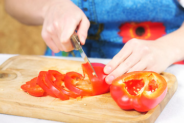 Image showing Woman hands slices paprika