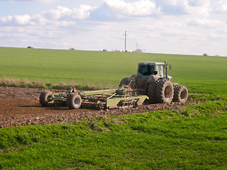 Image showing Tractor ploughing field