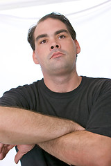 Image showing looking up at man with arms crossed