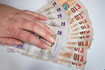 Image showing hand on £200 cash