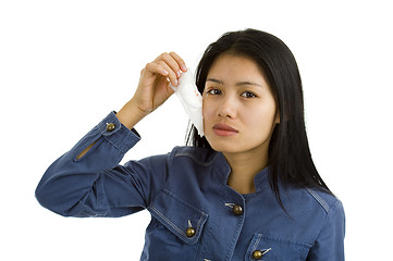 Image showing young woman removing bandage from her eye