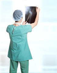 Image showing doctor holding up xrays.