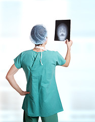 Image showing doctor holding up xrays.