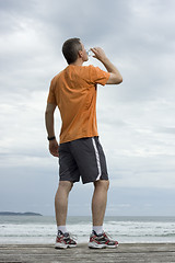 Image showing Mature athlete drinking water