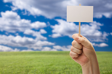 Image showing Blank Sign in Fist Over Grass Field and Sky