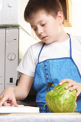 Image showing Boy with cabbage and cookbook