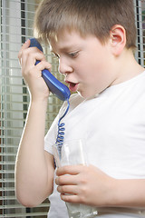 Image showing Angry boy in white shouts to phone