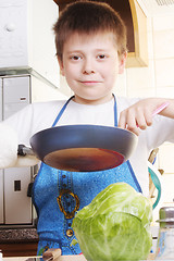 Image showing Smiling boy with frying-pan