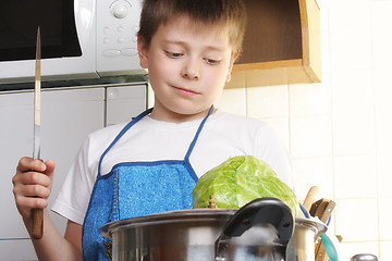 Image showing Boy with cabbage and knife
