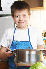 Image showing Smiling boy with saucepan