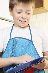 Image showing Smiling boy rubbing plate