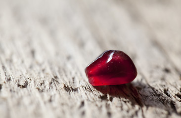 Image showing Pomegranate aril on wooden board