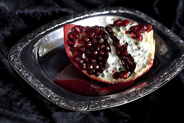 Image showing Sliced Pomegranate with arils on silver plate