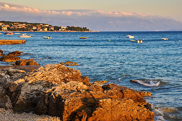 Image showing Motor Boats on the Water at Sunset on the Background of Mountain