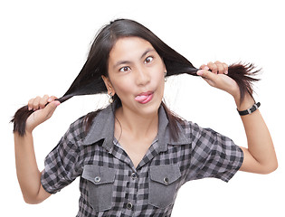 Image showing Crazy humorous girl pulling braids