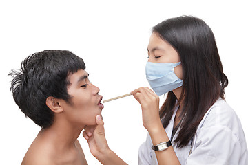 Image showing Doctor examining patient throat w spatula