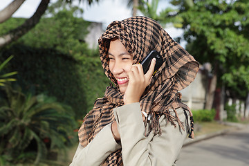 Image showing Muslim girl calling by cellphone
